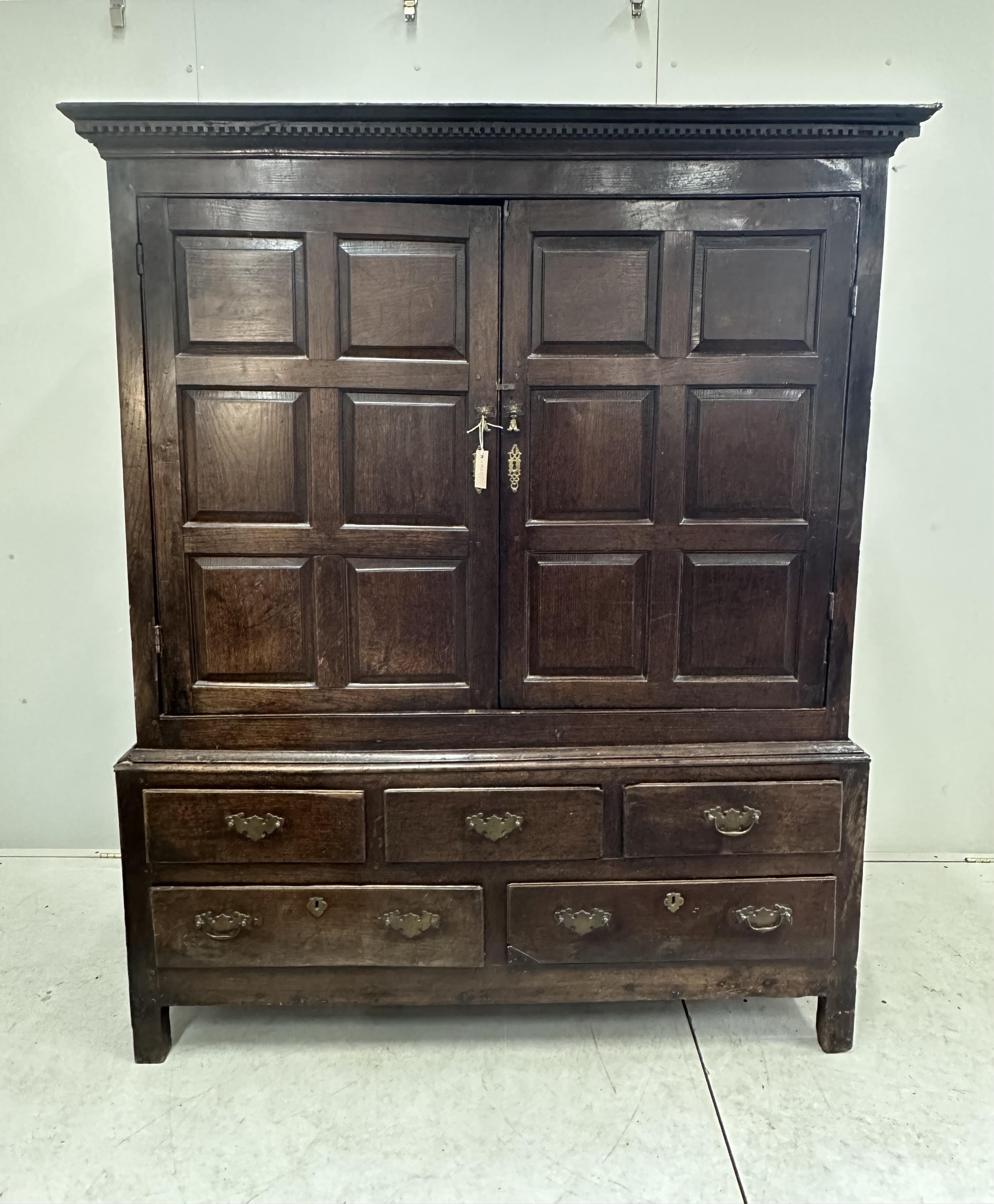 An 18th century panelled oak press cupboard, width 150cm, depth 65cm, height 183cm. Condition - poor to fair